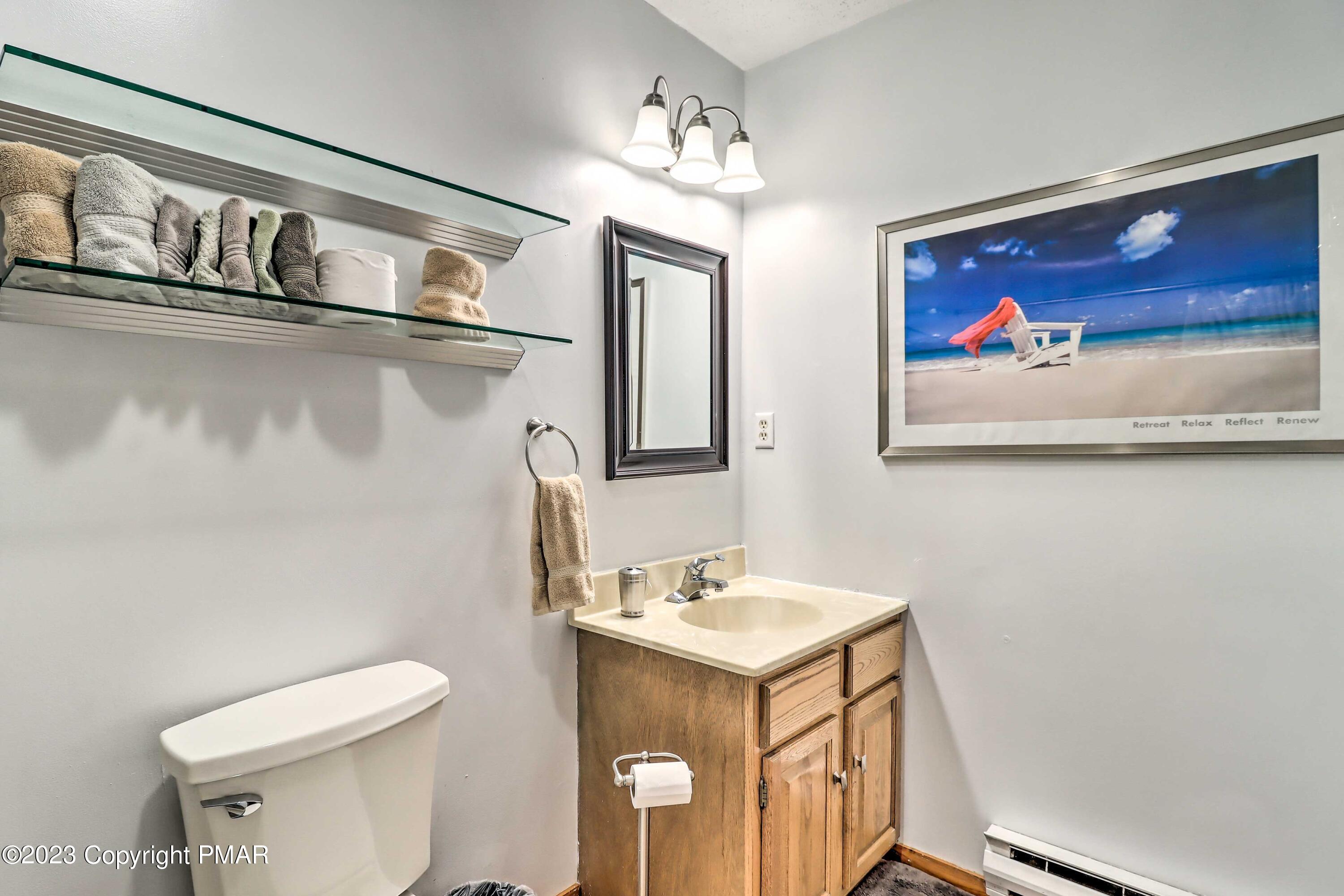 296 Overlook Way Tannersville, PA 18372 - Photo 16 of 44 a bathroom with a toilet a sink and mirror