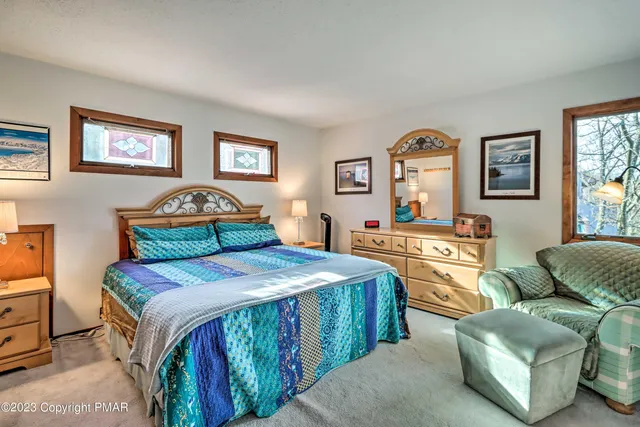 a bedroom with a bed and a couch