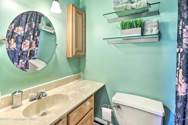 a bathroom with a sink mirror and toilet