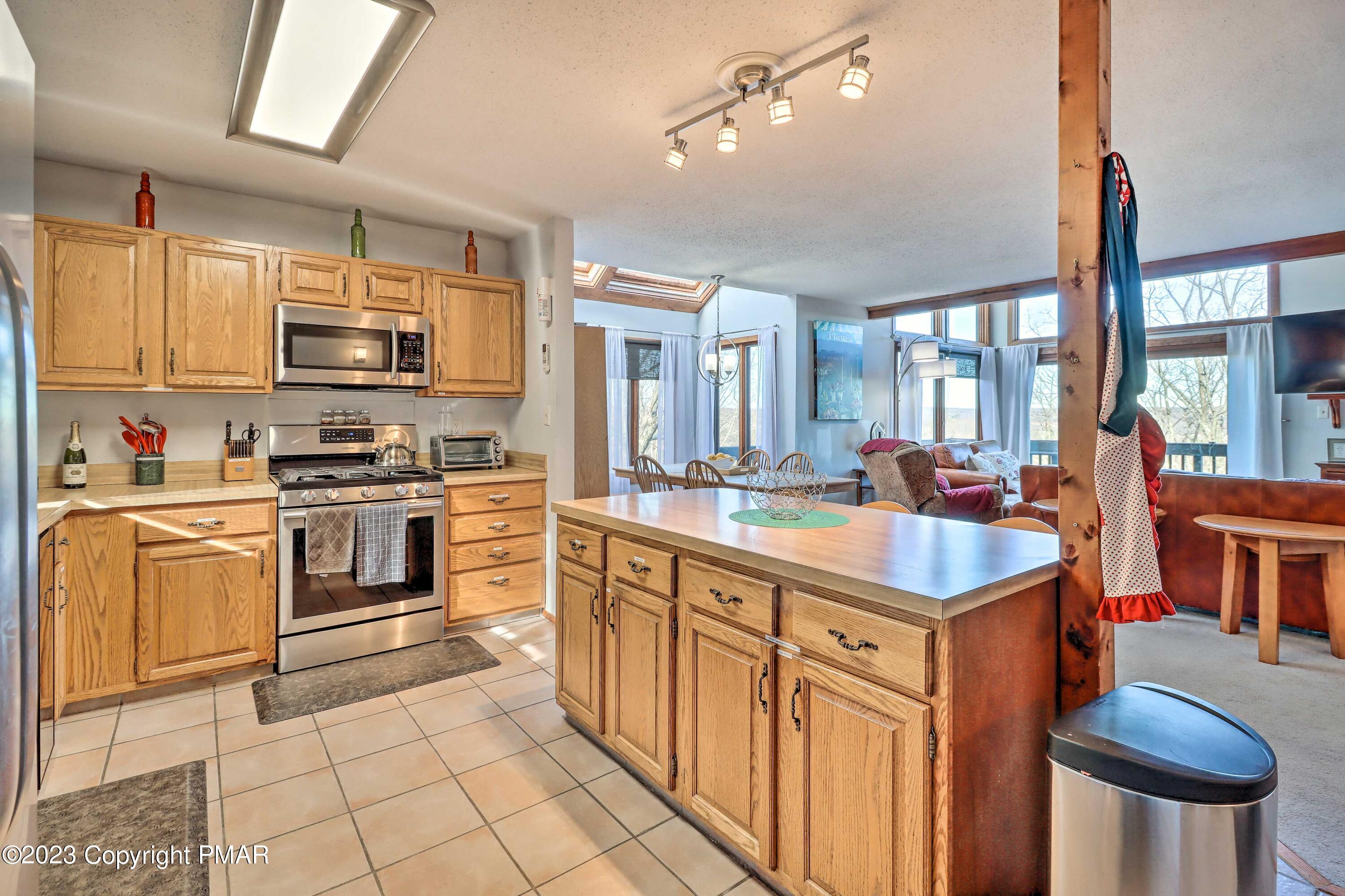 296 Overlook Way Tannersville, PA 18372 - Photo 3 of 44 a kitchen with stainless steel appliances kitchen island granite countertop a sink and cabinets