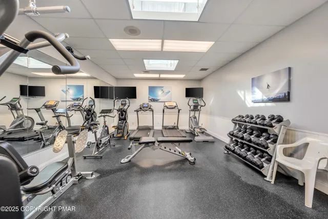 a room with gym equipment and a table
