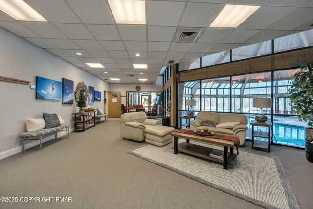 a view of a livingroom with workspace and a window