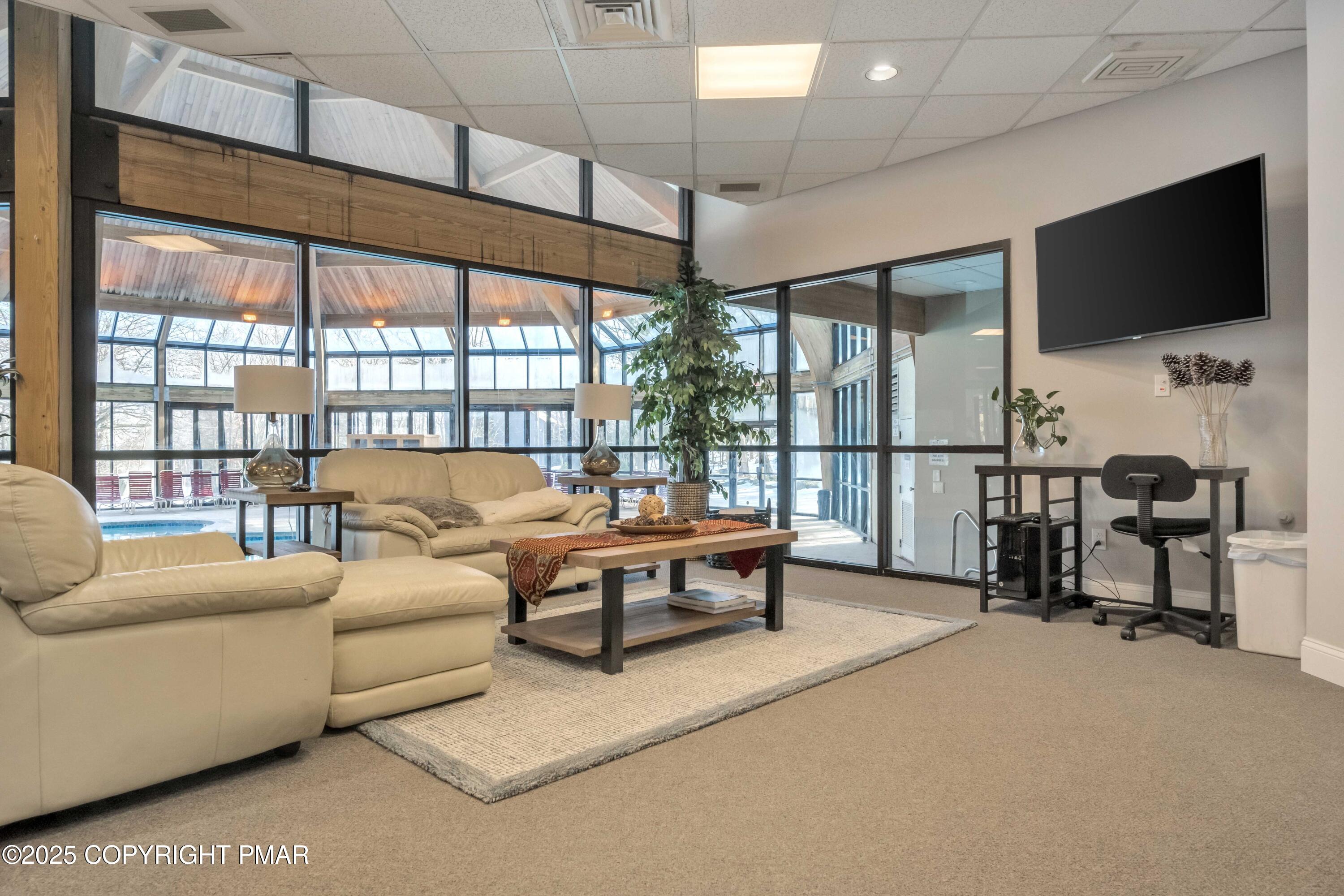 296 Overlook Way Tannersville, PA 18372 - Photo 43 of 44 a living room with furniture a flat screen tv and floor to ceiling window