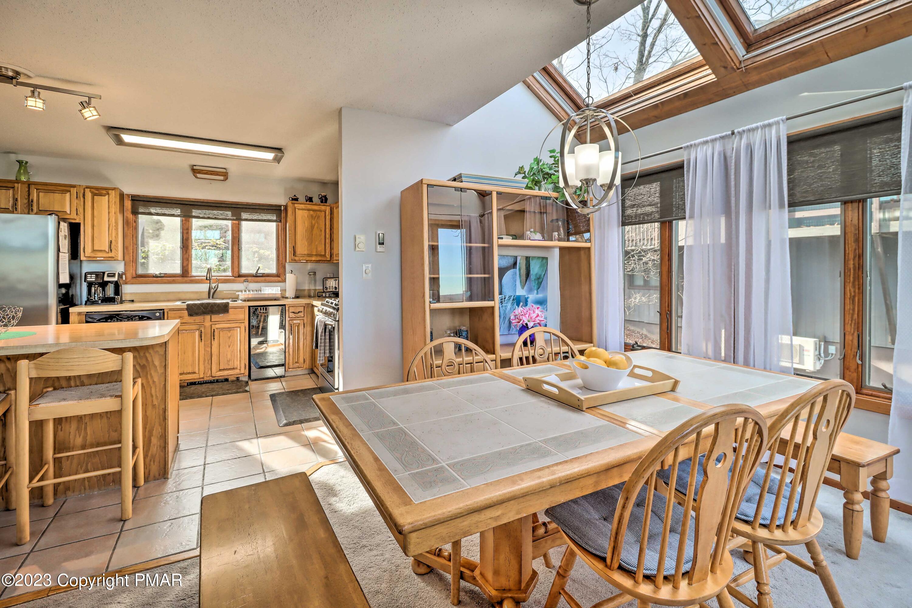 296 Overlook Way Tannersville, PA 18372 - Photo 7 of 44 a kitchen with stainless steel appliances granite countertop a dining table chairs and granite counter tops