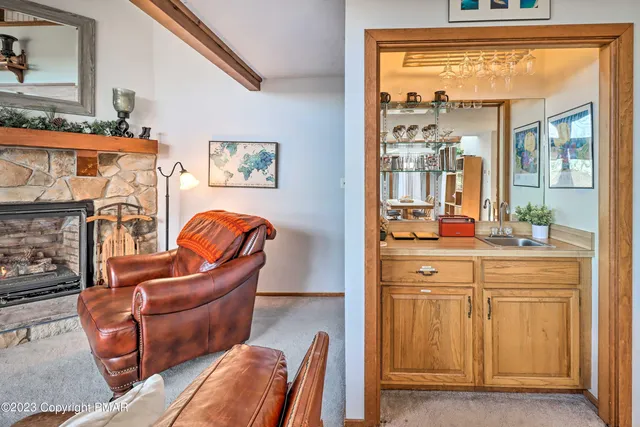 a living room with furniture a fireplace and next to a window