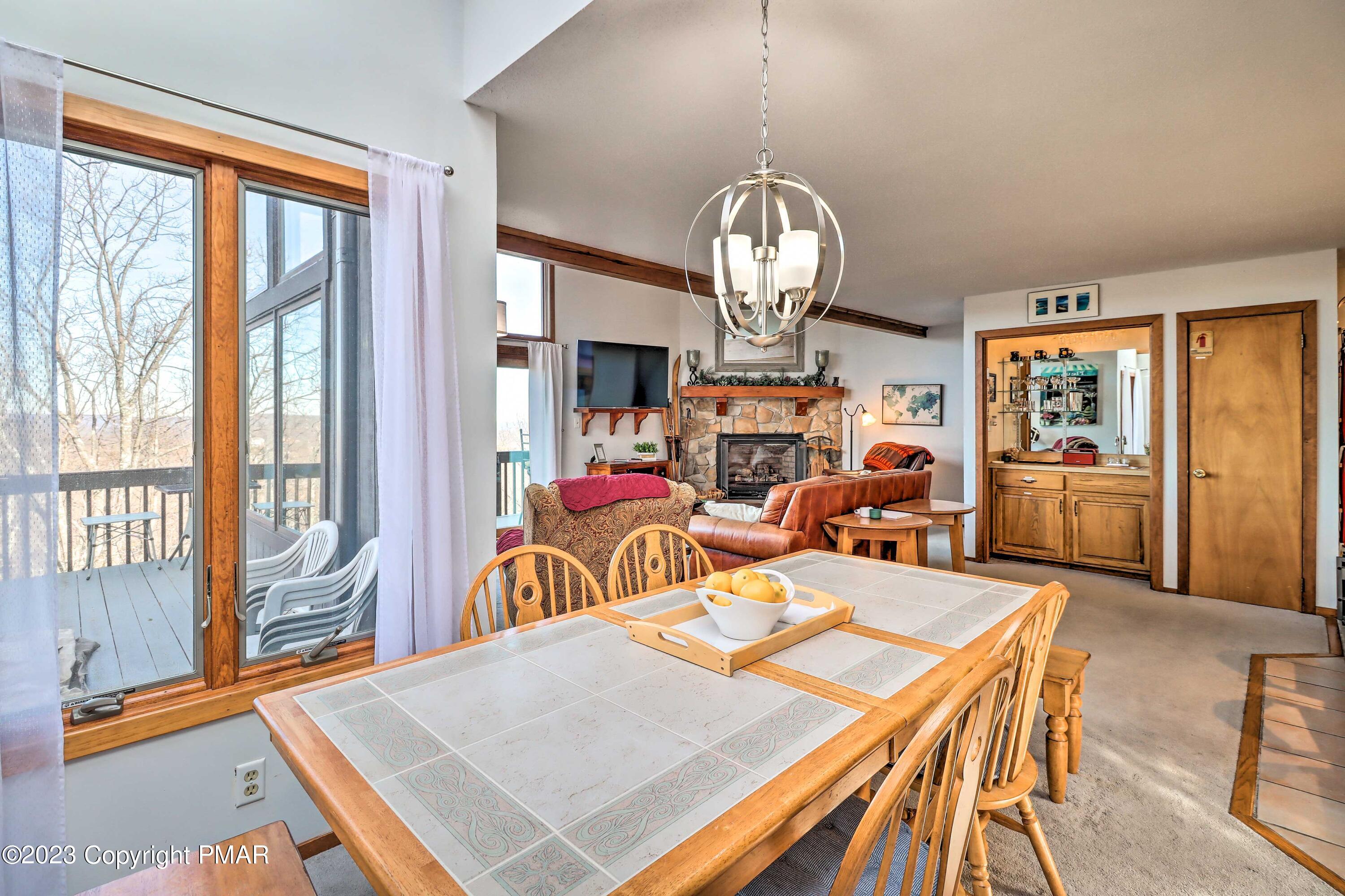 296 Overlook Way Tannersville, PA 18372 - Photo 9 of 44 a view of a dining room with furniture a chandelier and wooden floor