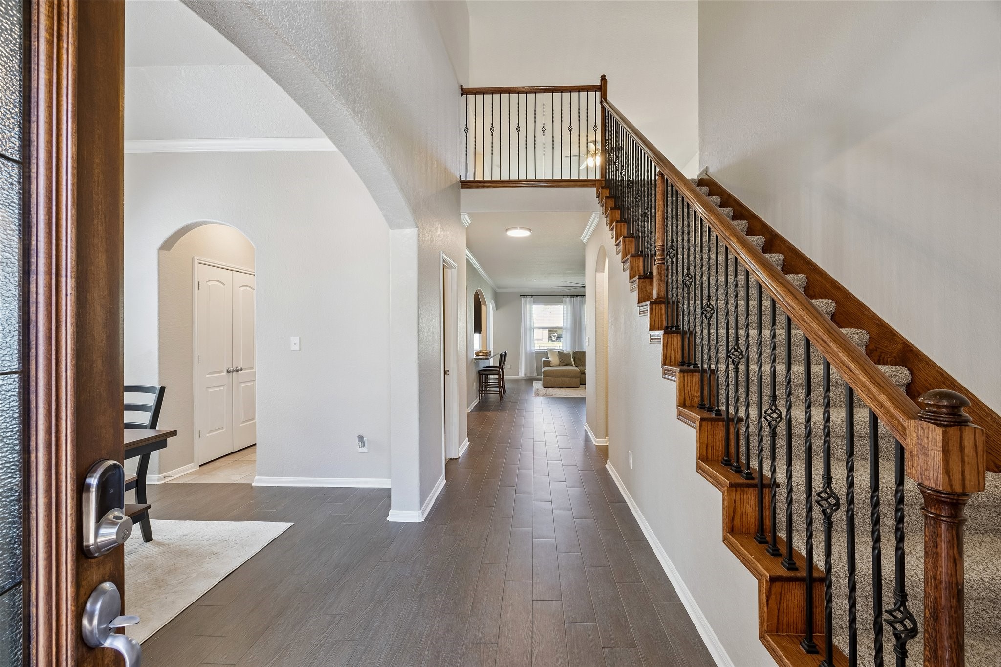 5922 Watford Bend Rosenberg, TX 77471 - Photo 19 of 34 a view of a hallway with wooden floor and stairs