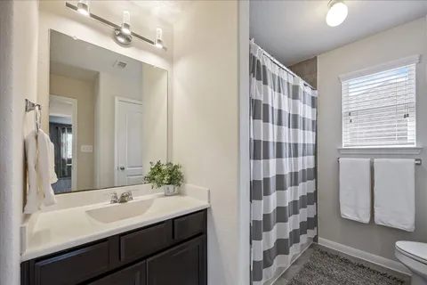 a bathroom with a sink a large mirror and shower
