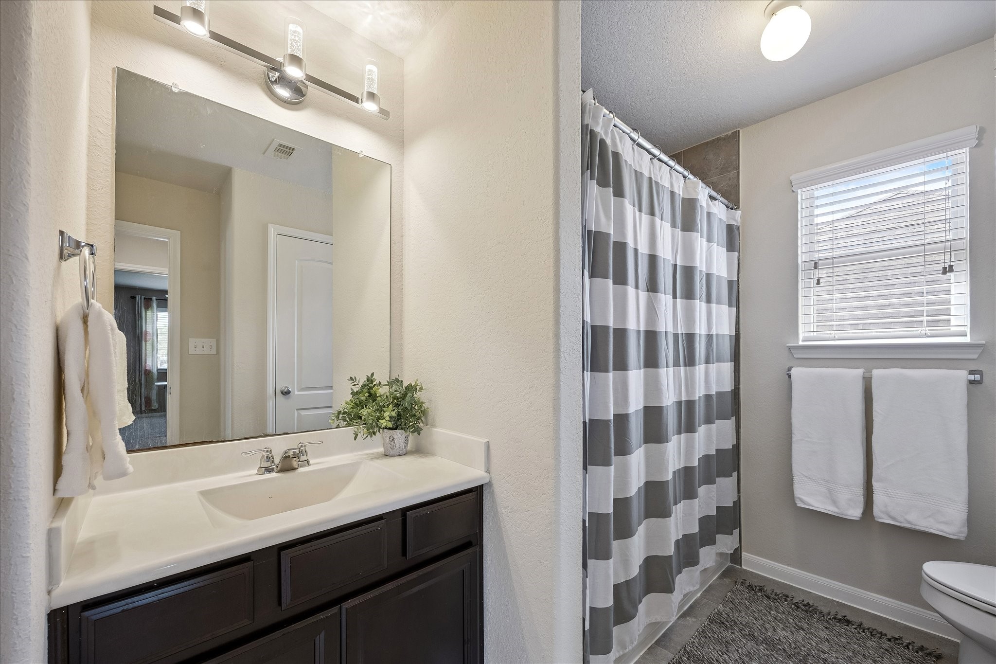 5922 Watford Bend Rosenberg, TX 77471 - Photo 24 of 34 a bathroom with a sink a large mirror and shower
