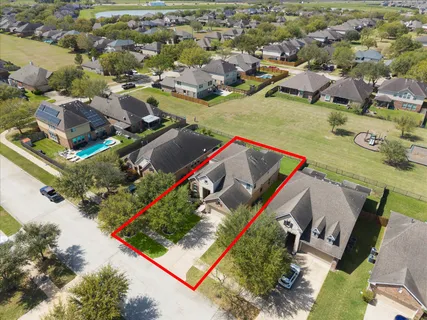 an aerial view of residential houses with outdoor space