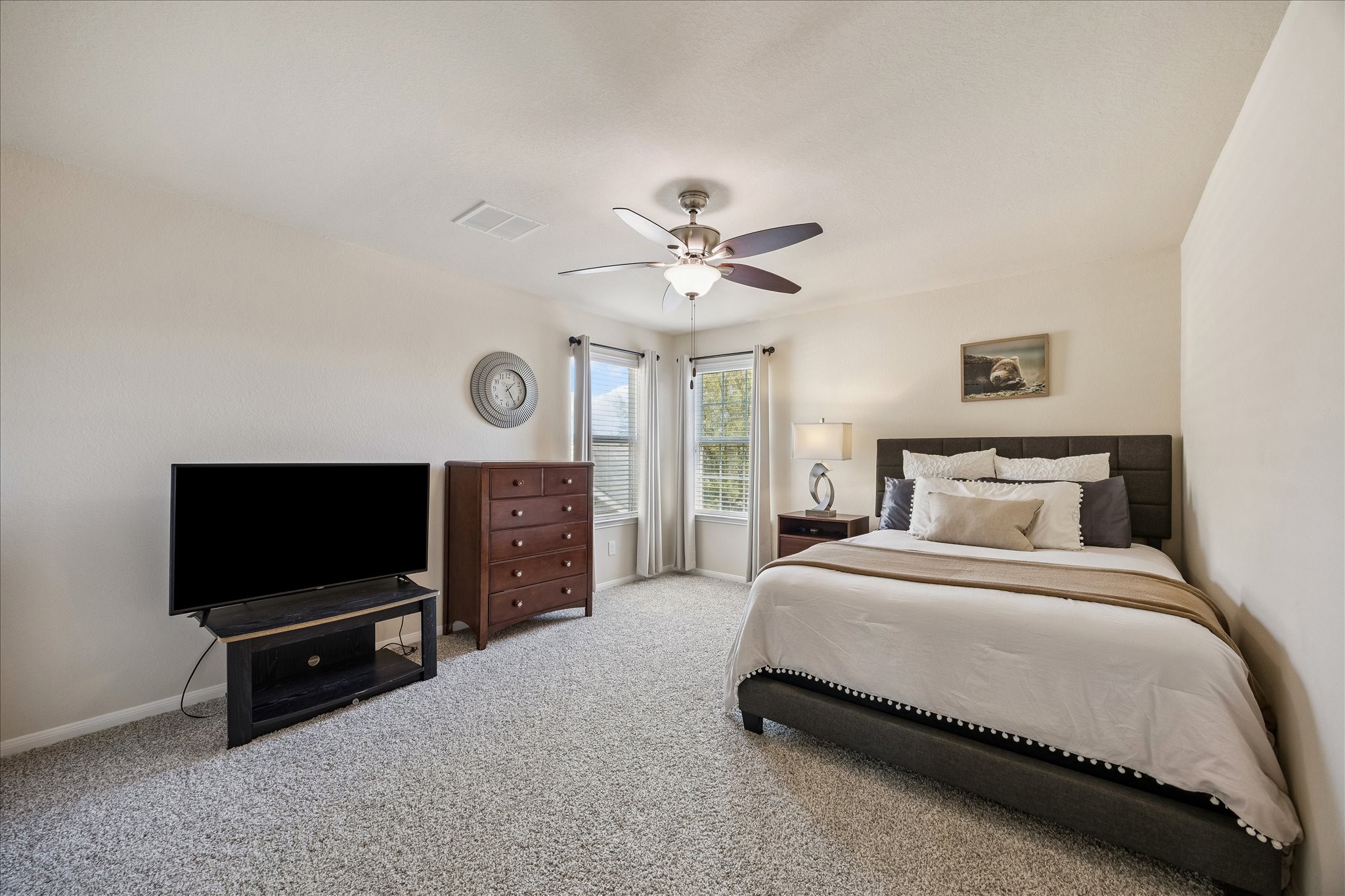 5922 Watford Bend Rosenberg, TX 77471 - Photo 31 of 34 a spacious bedroom with a bed and a flat screen tv