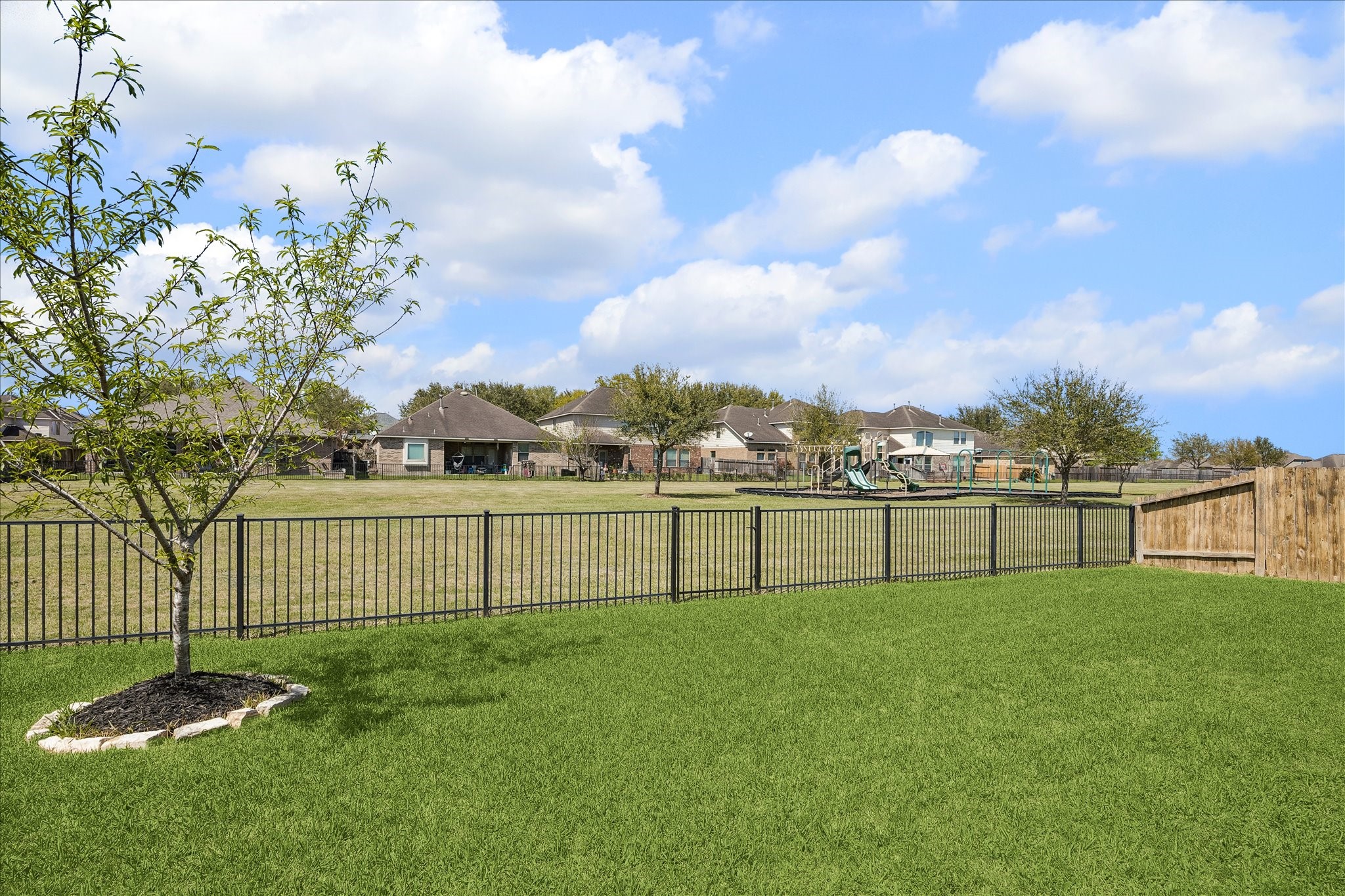 5922 Watford Bend Rosenberg, TX 77471 - Photo 5 of 34 VIEW FROM BACKYARD Fully fenced with sprinkler system front and back, this lot backs to a community greenbelt with a pocket park shaded by mature Live Oak trees affording more space for outdoor recreation.