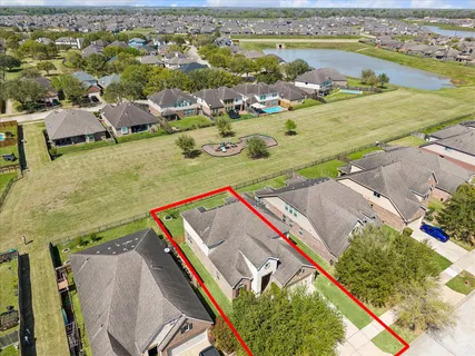 an aerial view of residential houses with outdoor space