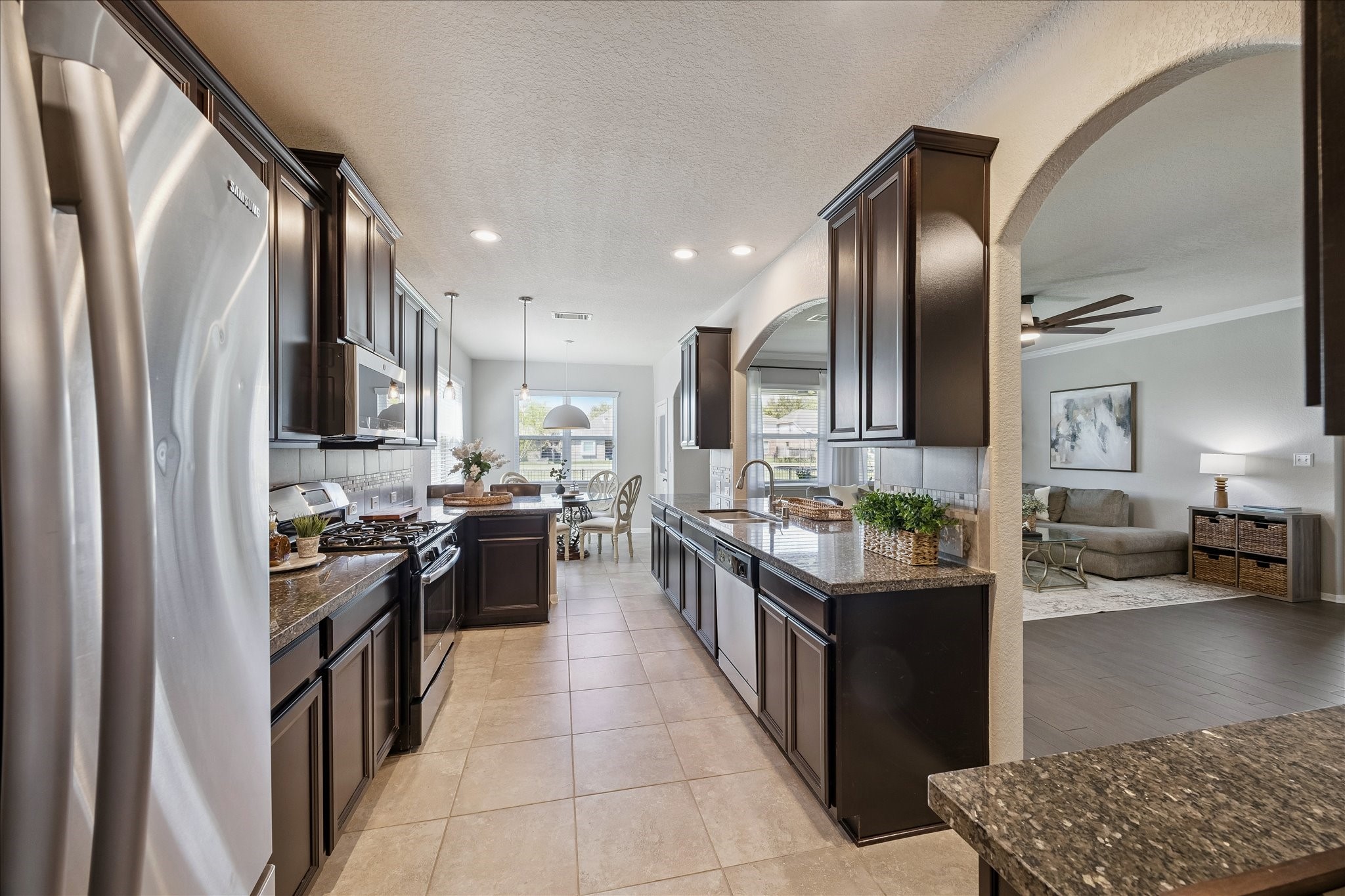 5922 Watford Bend Rosenberg, TX 77471 - Photo 8 of 34 a kitchen with stainless steel appliances granite countertop a sink stove and refrigerator