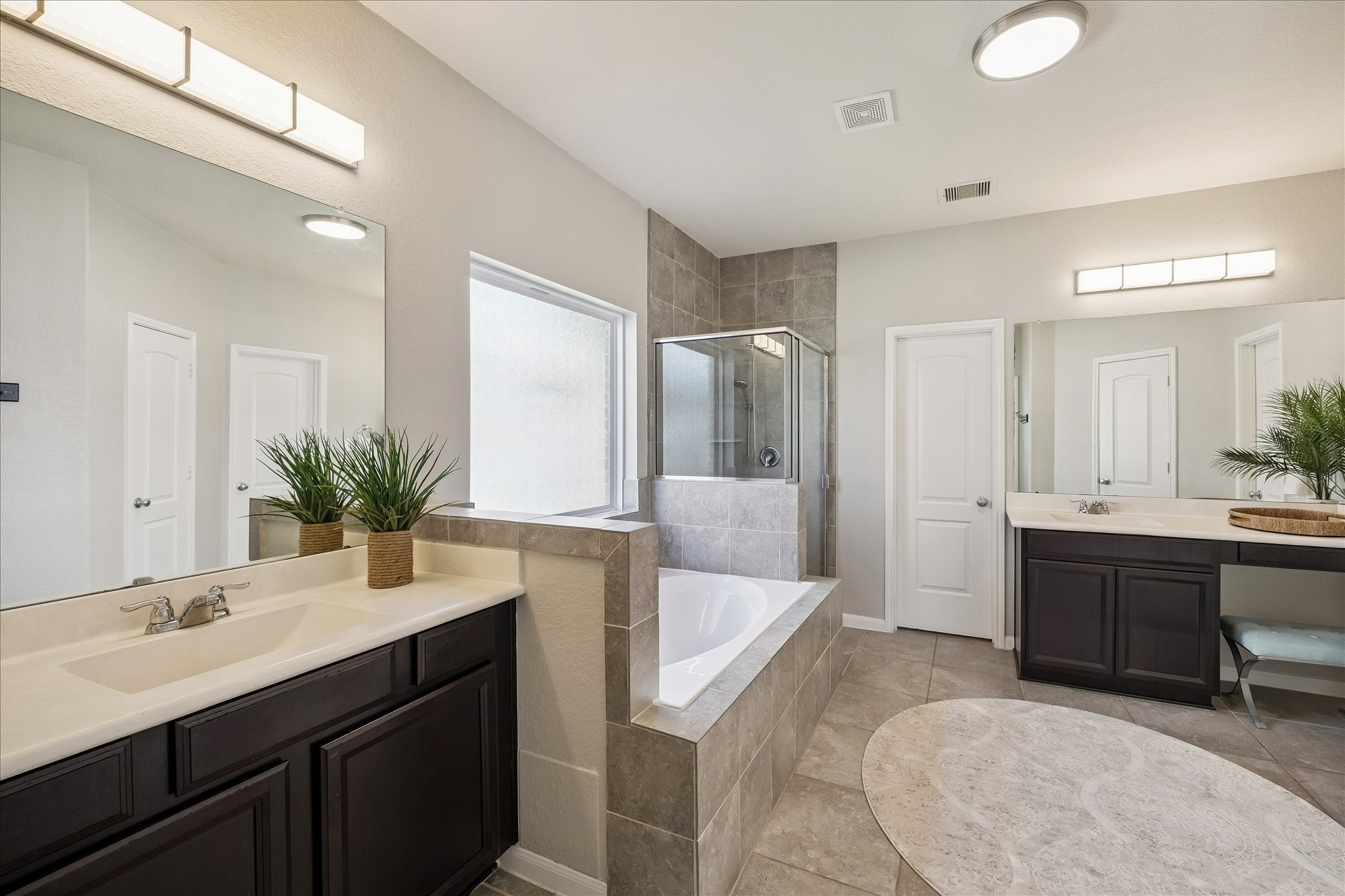 5922 Watford Bend Rosenberg, TX 77471 - Photo 10 of 34 PRIMARY BATHROOM A lavish bathroom beckons with HIS and HERS sinks, HERS with a vanity space. Upgraded light fixtures.