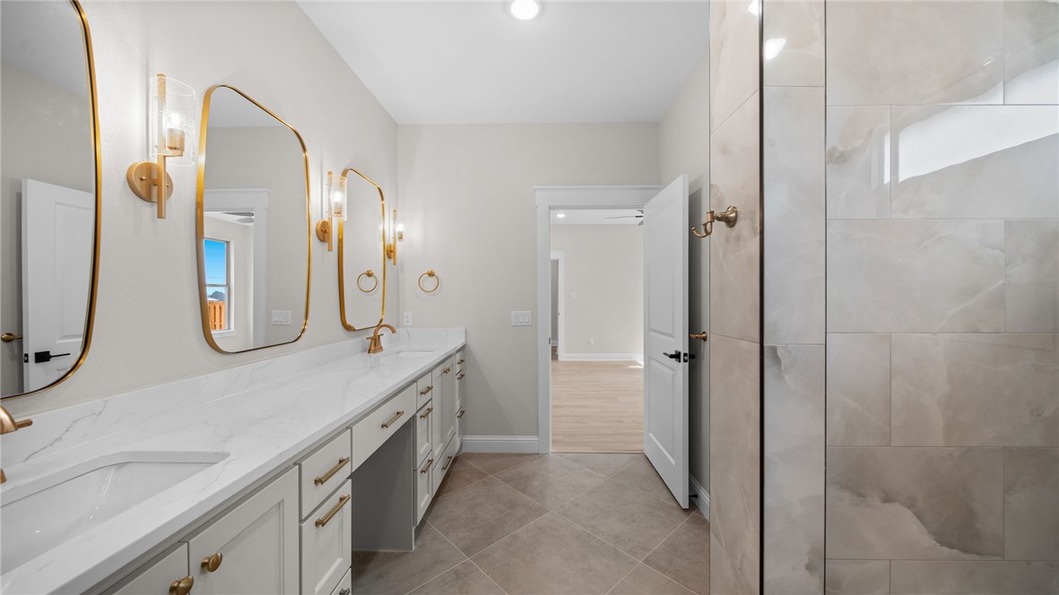 162 Buffalo Rdg Road Giddings, TX 78942 - Photo 15 of 31 a spacious bathroom with a double vanity sink a mirror and a shower