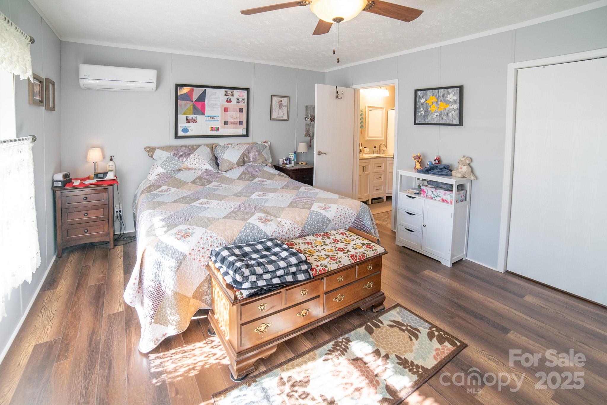 3122 Vance Denton Road Morganton, NC 28655 - Photo 14 of 42 a bedroom with a bed and a chandelier