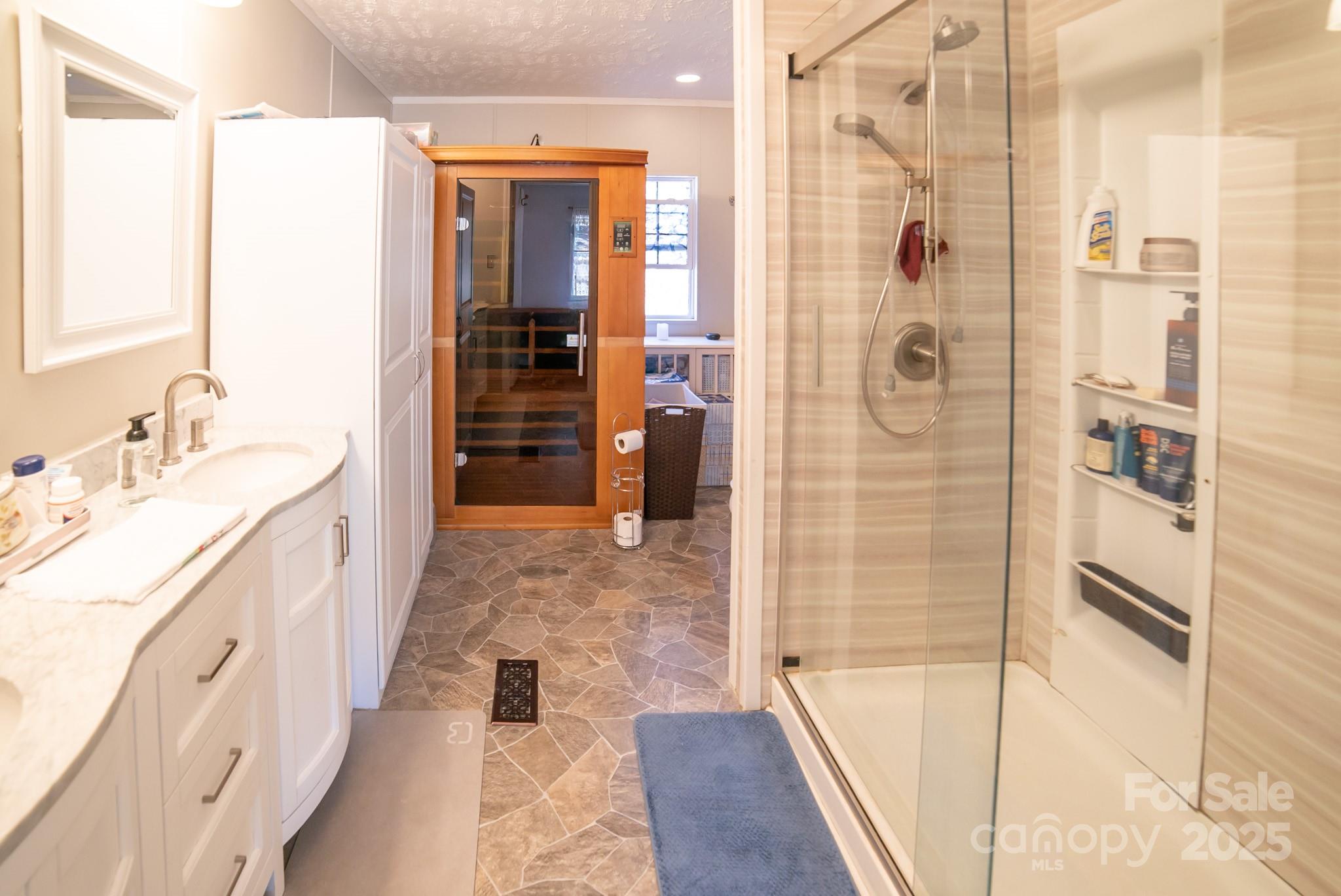 3122 Vance Denton Road Morganton, NC 28655 - Photo 15 of 42 a bathroom with a double vanity sink and shower