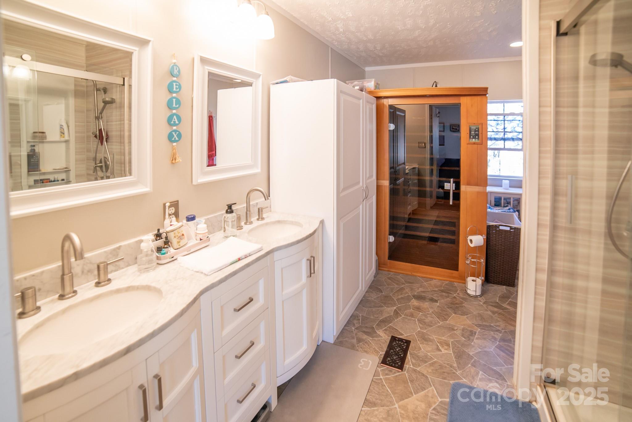 3122 Vance Denton Road Morganton, NC 28655 - Photo 16 of 42 a spacious bathroom with a double vanity sink a mirror and shower