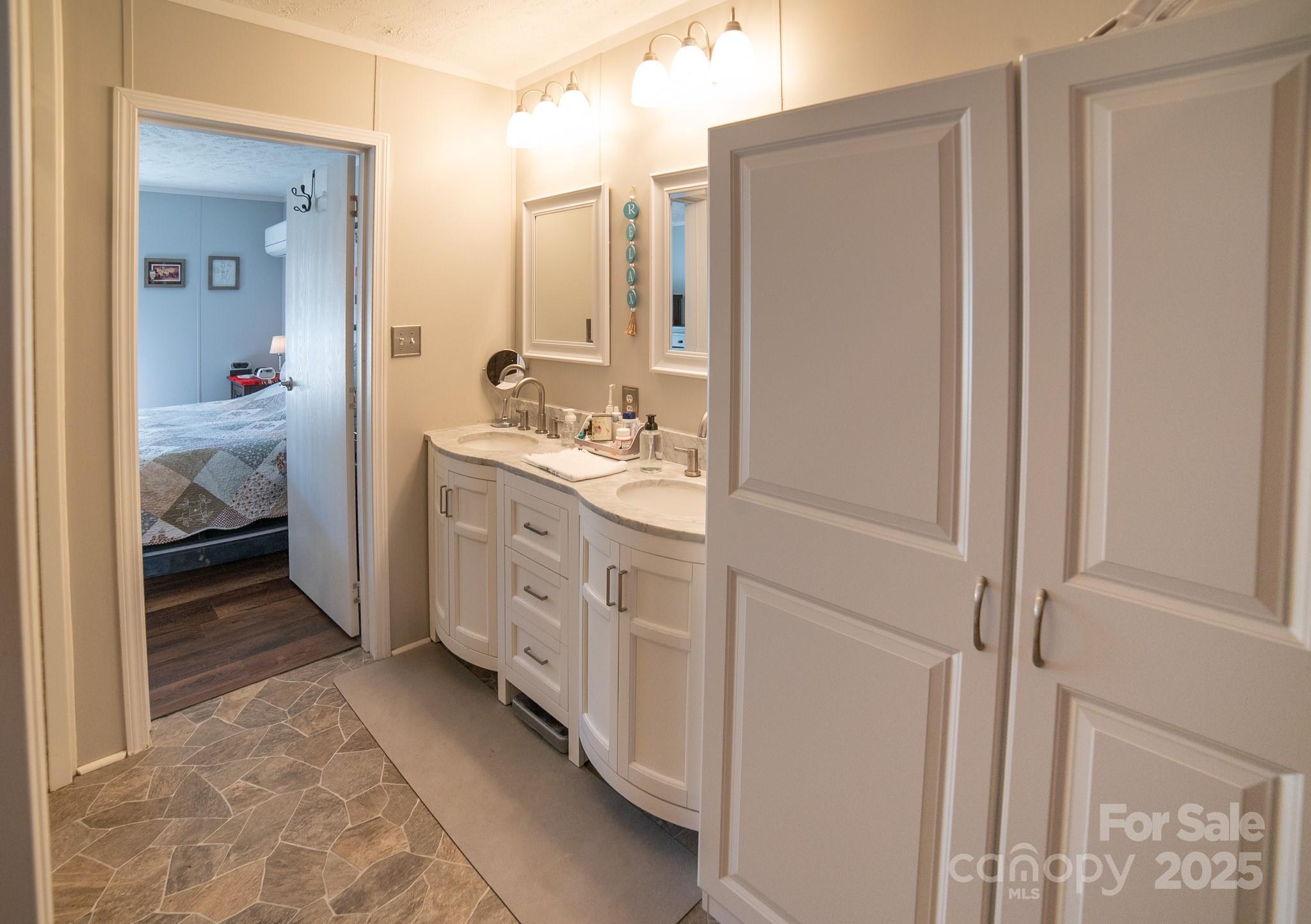 3122 Vance Denton Road Morganton, NC 28655 - Photo 18 of 42 a bathroom with a double vanity sink and a mirror