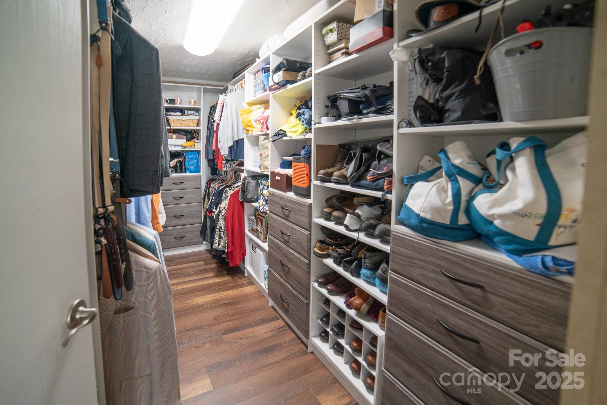 3122 Vance Denton Road Morganton, NC 28655 - Photo 19 of 42 a view of walk in closet with clothes and shoes