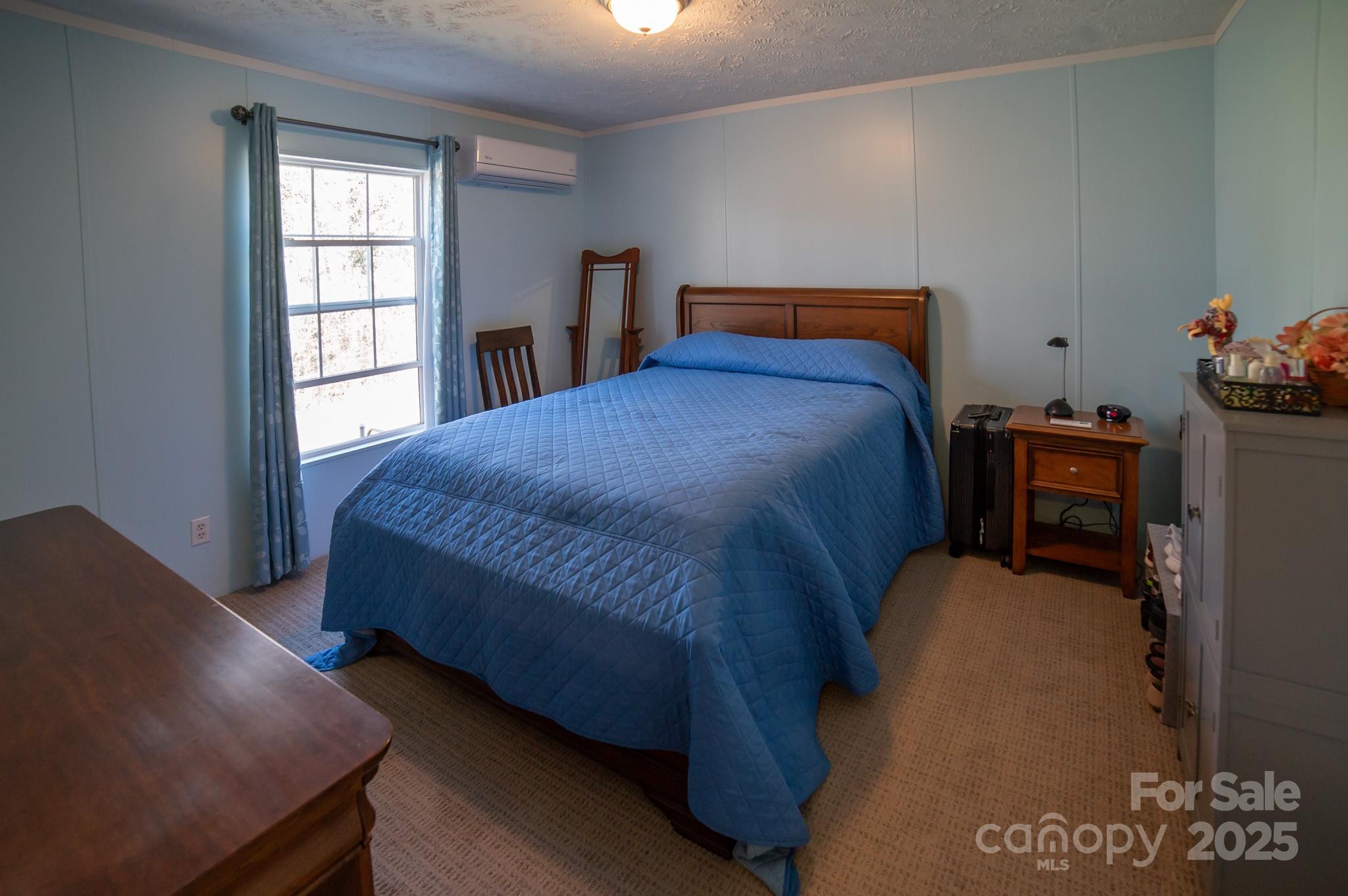 3122 Vance Denton Road Morganton, NC 28655 - Photo 22 of 42 a bed sitting in a bedroom next to a window