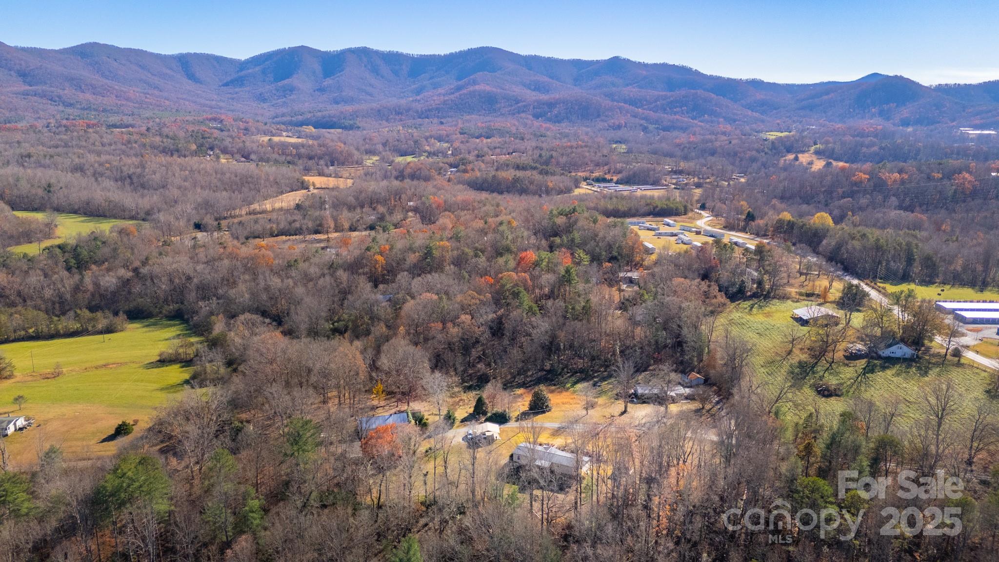 3122 Vance Denton Road Morganton, NC 28655 - Photo 34 of 42 a view of a lush green hillside and a houses