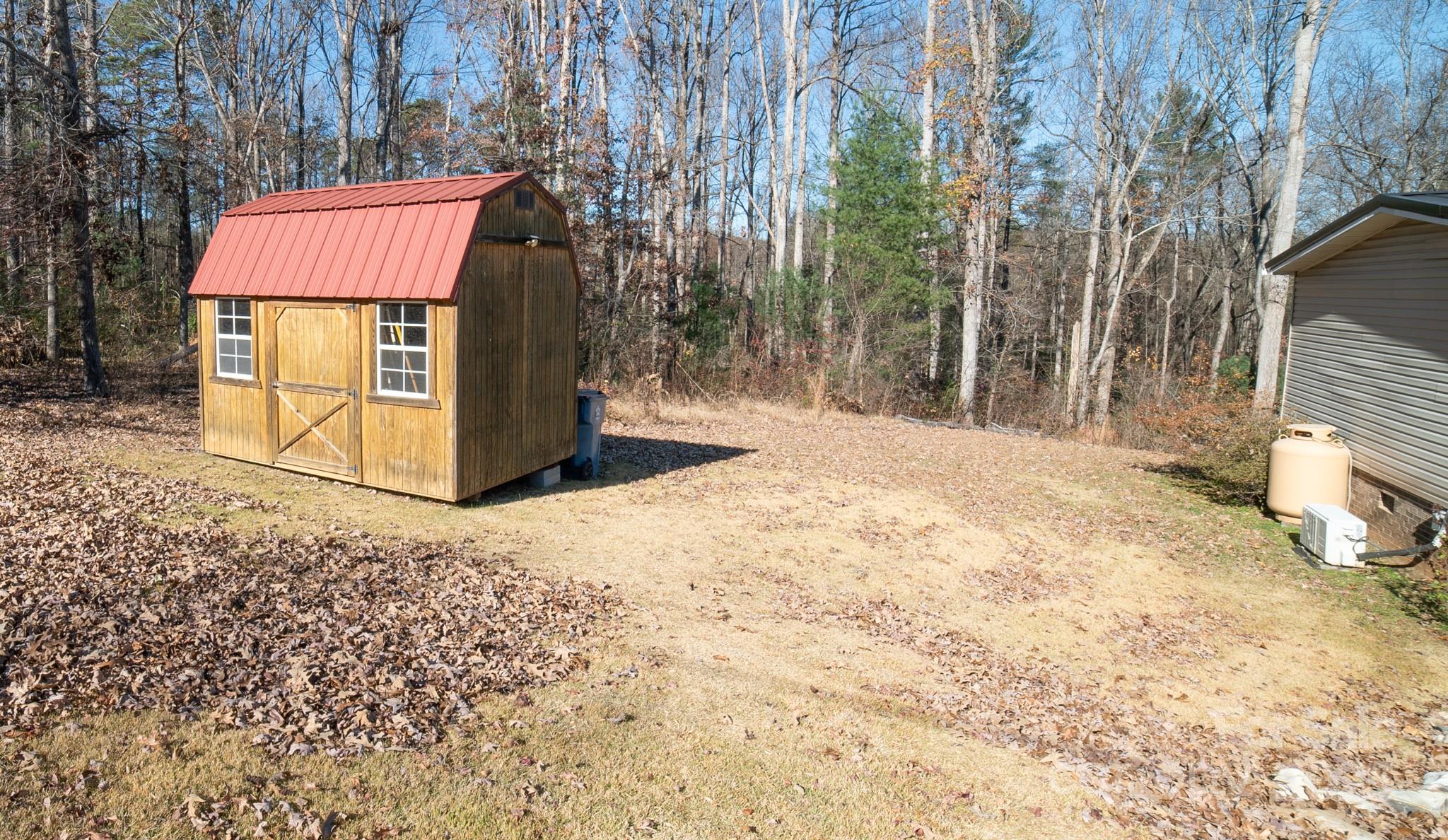 3122 Vance Denton Road Morganton, NC 28655 - Photo 42 of 42 a bench is sitting in the middle of a yard