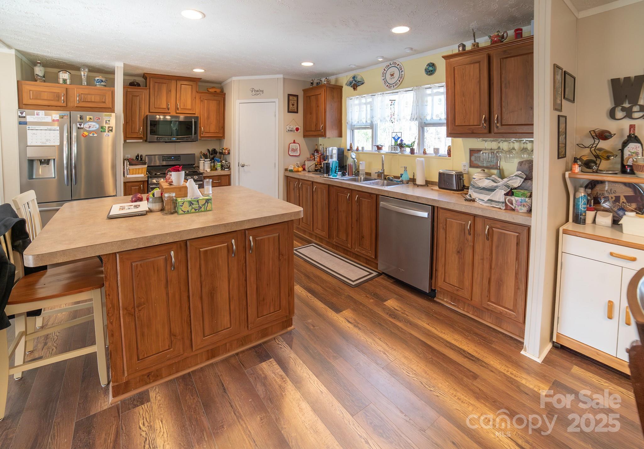 3122 Vance Denton Road Morganton, NC 28655 - Photo 7 of 42 a kitchen with kitchen island granite countertop a sink cabinets and stainless steel appliances