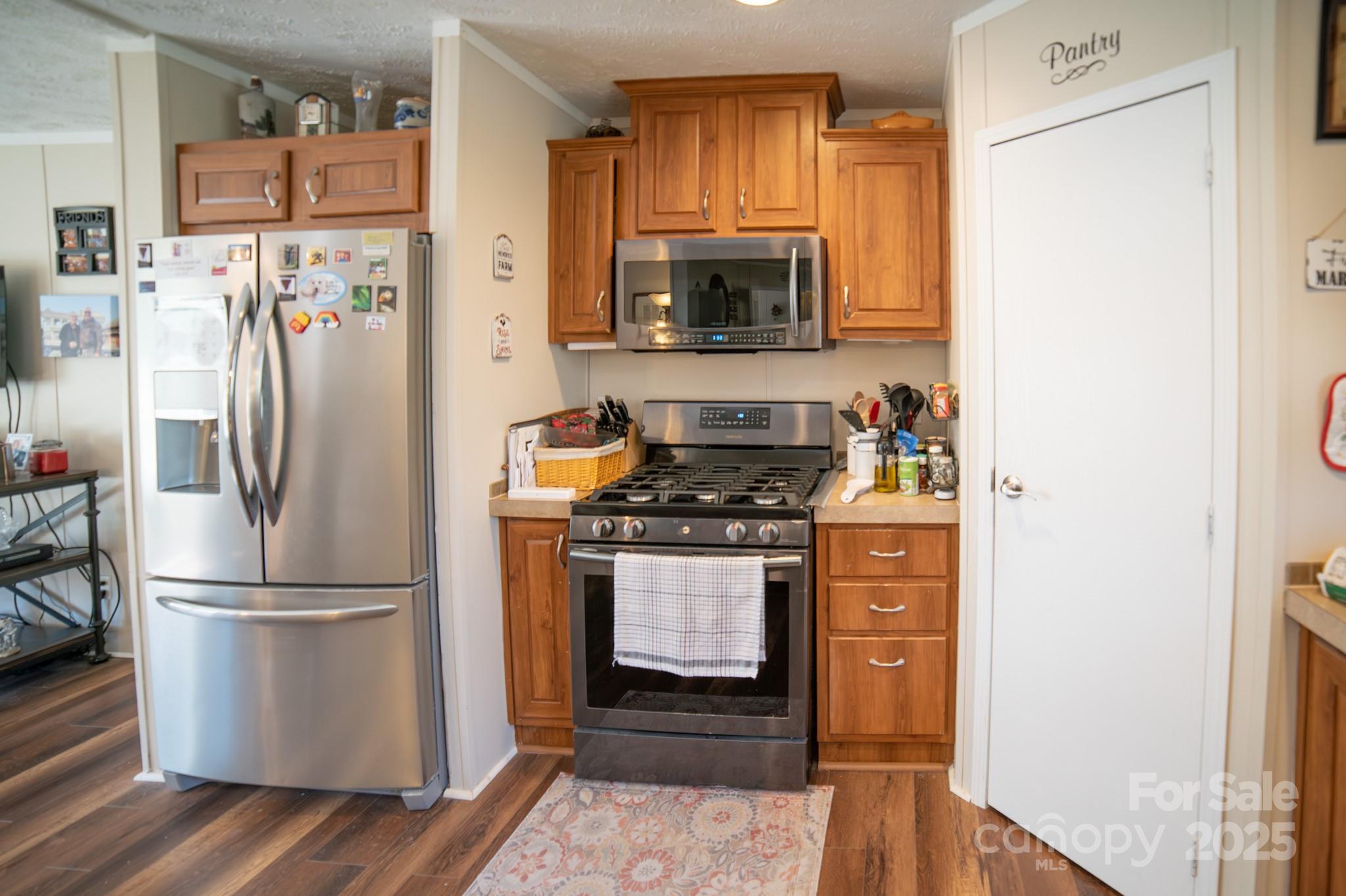 3122 Vance Denton Road Morganton, NC 28655 - Photo 9 of 42 a kitchen with stainless steel appliances a refrigerator stove and microwave