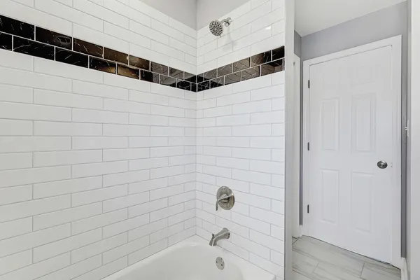a bathroom with a bathtub and shower