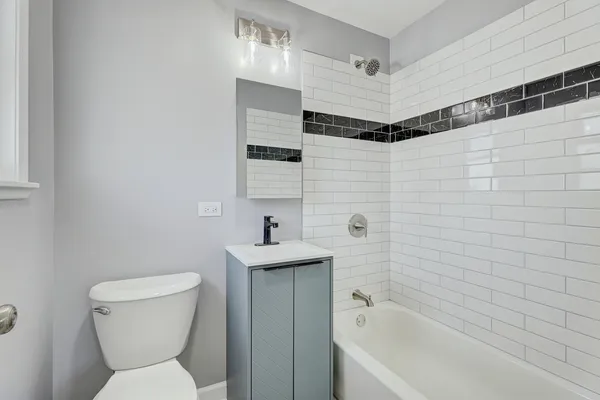 a bathroom with a toilet a sink and bathtub