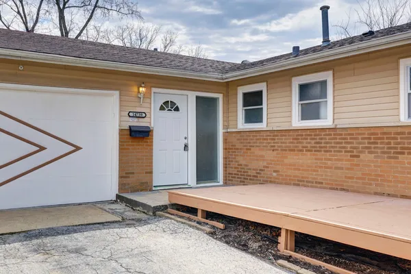a view of a house with a wooden deck