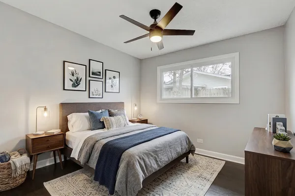 a bedroom with a large bed and a window