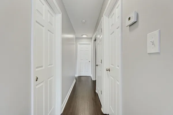 a view of a hallway with a wooden floors