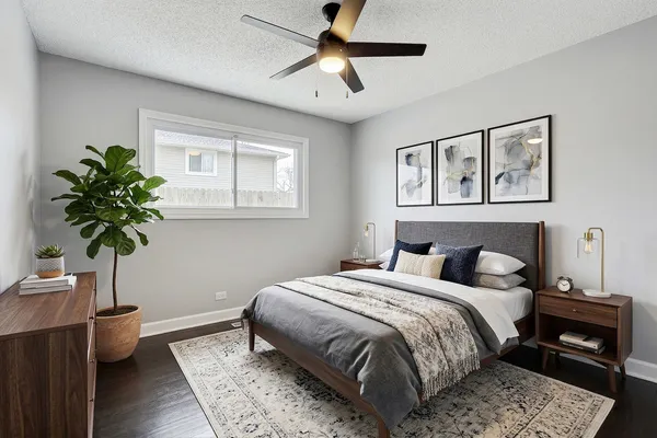 a bedroom with a bed and a potted plant