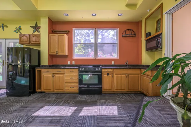 a living room with furniture a fireplace and a floor to ceiling window