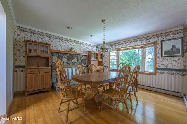 a spacious bedroom with a bed window and table chair