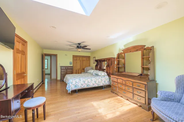 a bedroom with a bed wooden floor and a table