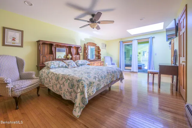 a en suite bathroom with a granite countertop sink and a mirror