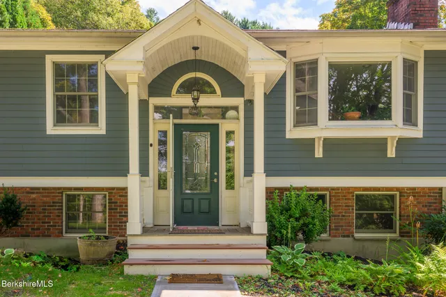 a front view of a house with a garden