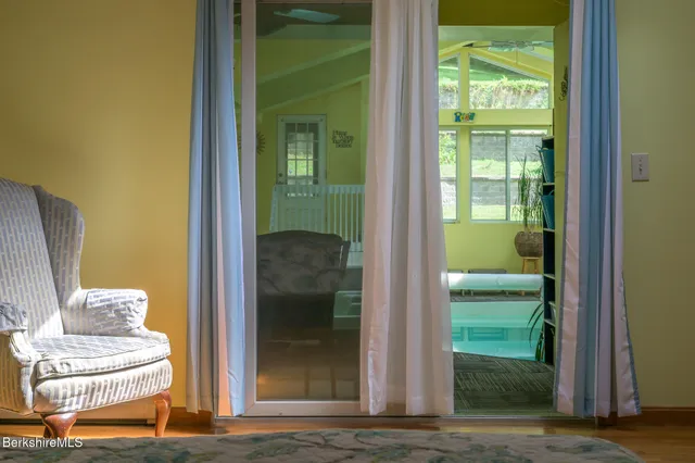 a view of a room with wooden floor and windows