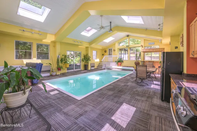 a room with lots of potted plants and a dining table