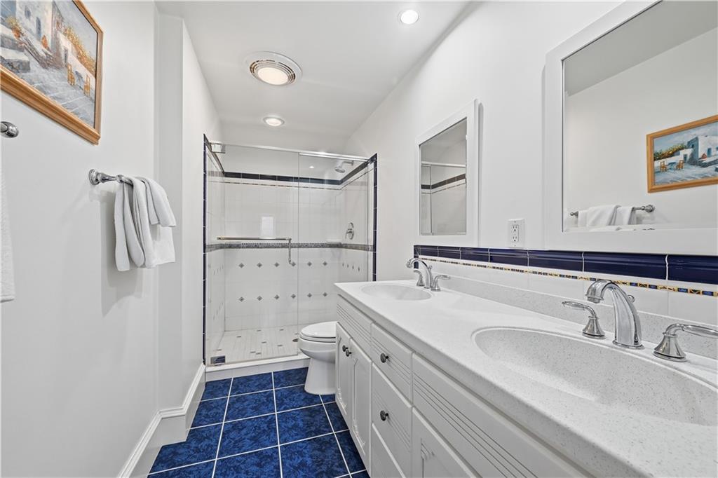 600 Backbone Road Sewickley, PA 15143 - Photo 47 of 50 The bath features double sinks, ample storage, and bright finishes that feel both polished and practical. It is a well-designed space with an easy, cheerful feel.