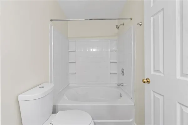 a bathroom with a toilet and a bathtub