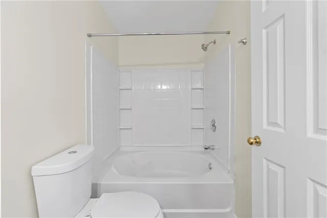 a bathroom with a toilet and a bathtub
