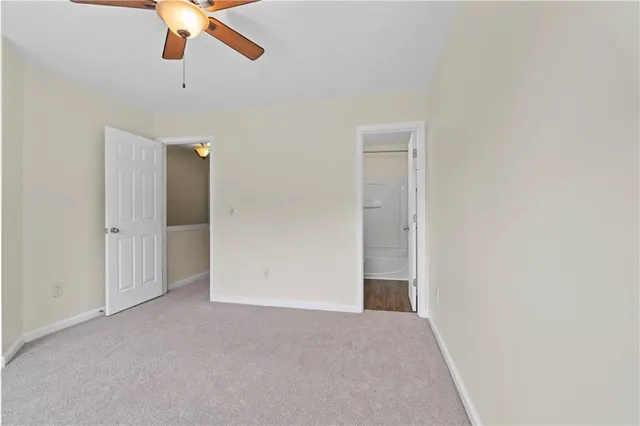 an empty room with closet and windows