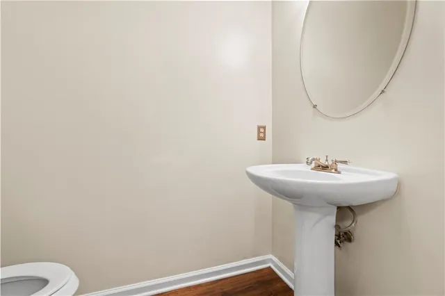 a bathroom with a sink a toilet and a mirror