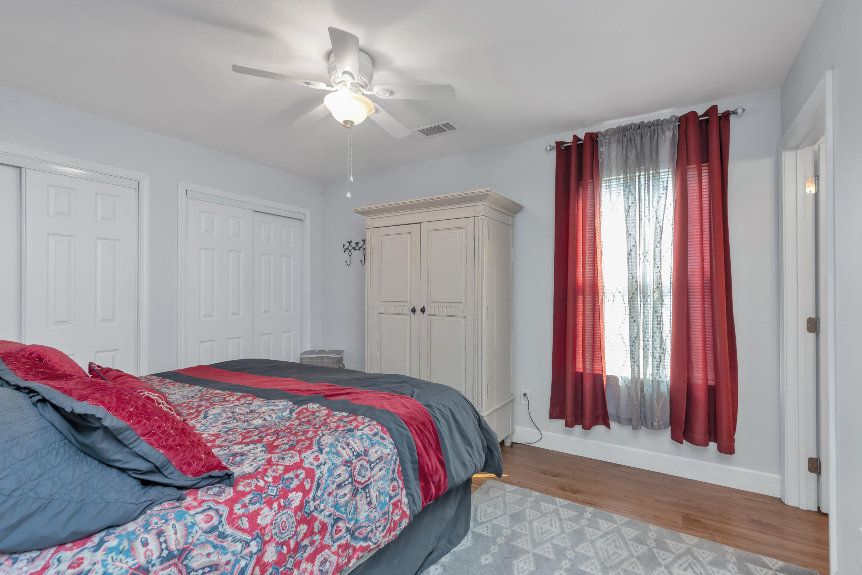 79 6th Street Santa Rosa Beach, FL 32459 - Photo 12 of 42 a bedroom with a bed and a chandelier