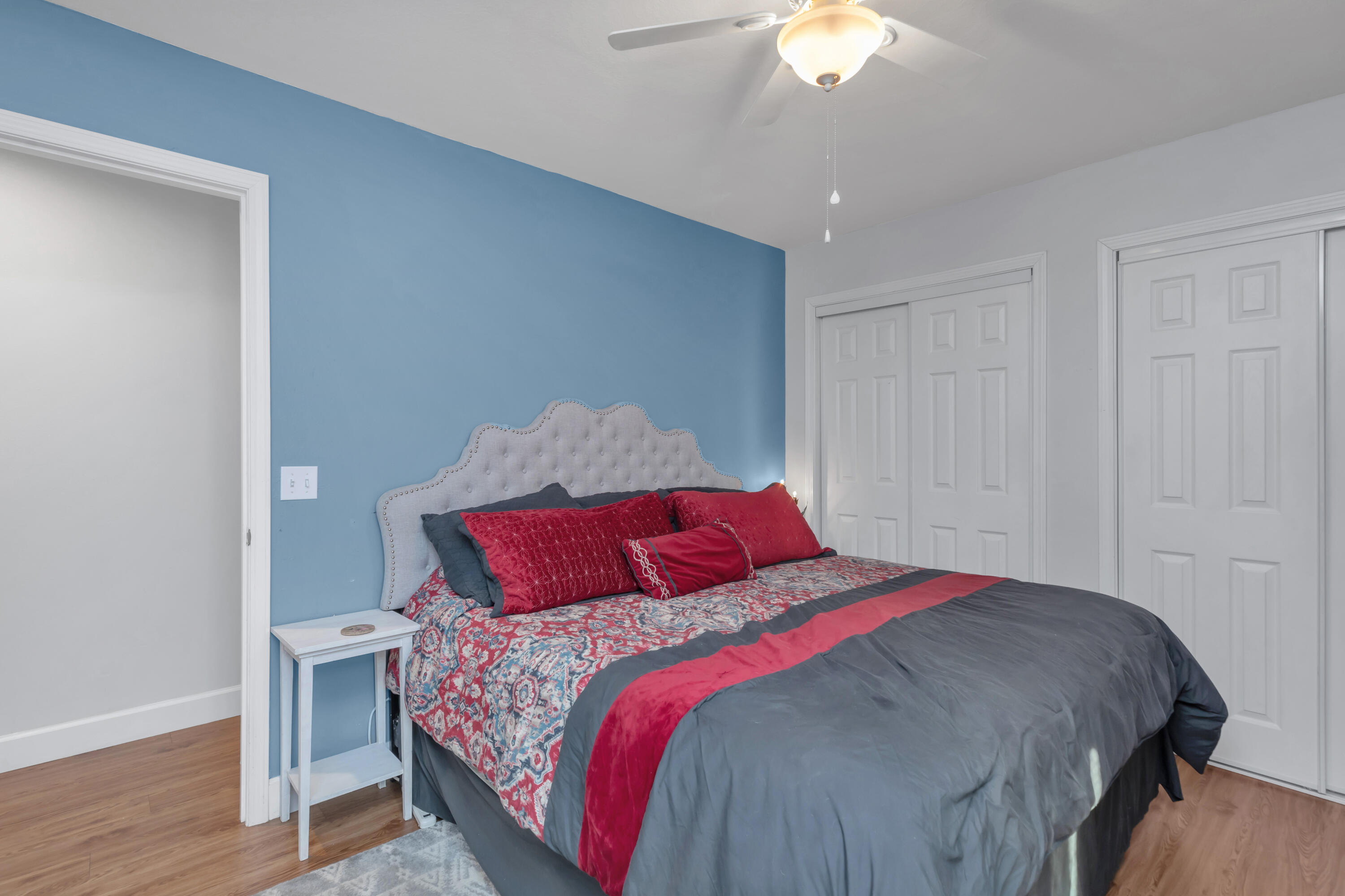 79 6th Street Santa Rosa Beach, FL 32459 - Photo 13 of 42 a bedroom with a bed and a chandelier
